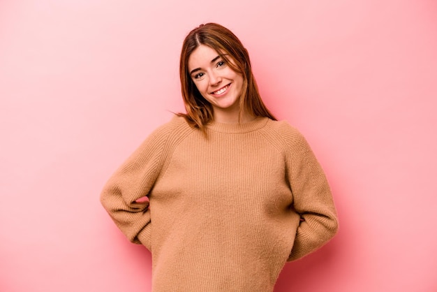 Young caucasian woman isolated on pink background happy smiling and cheerful