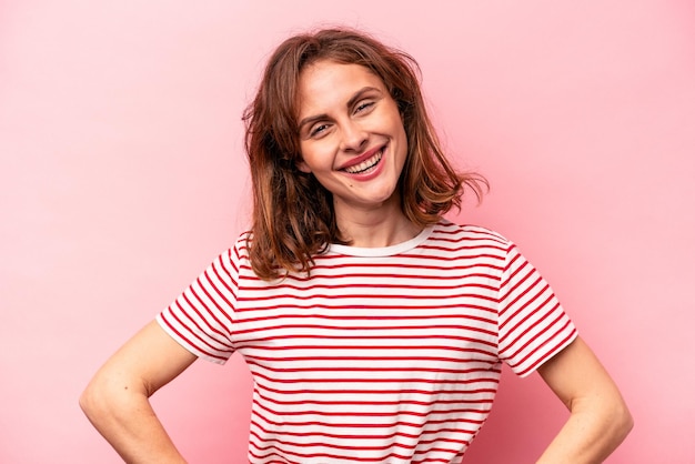 Young caucasian woman isolated on pink background happy smiling and cheerful