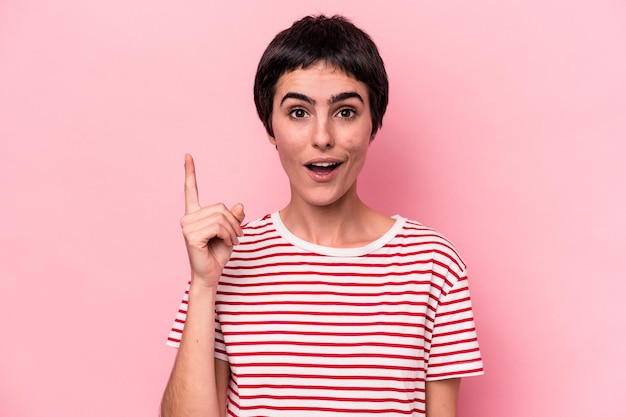 Young caucasian woman isolated on pink background having an idea inspiration concept