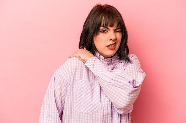 Young caucasian woman isolated on pink background having a shoulder pain