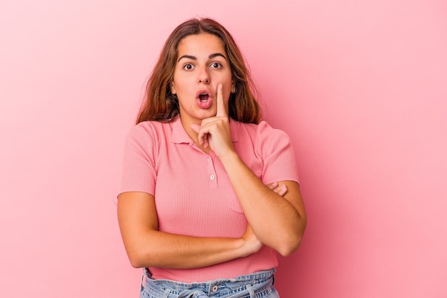 Young caucasian woman isolated on pink background  having some great idea, concept of creativity.