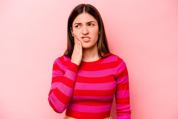 Young caucasian woman isolated on pink background having a strong teeth pain molar ache