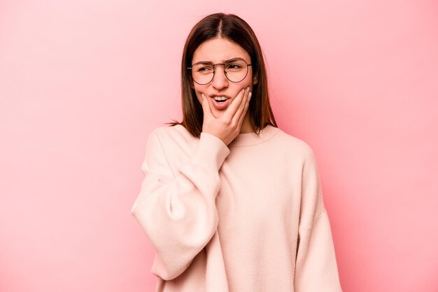 Photo young caucasian woman isolated on pink background having a strong teeth pain molar ache