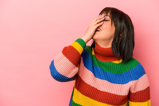 Young caucasian woman isolated on pink background laughing happy carefree natural emotion