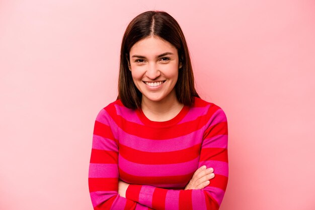 Young caucasian woman isolated on pink background laughing and having fun