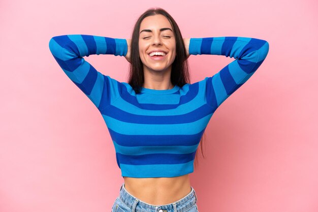 Young caucasian woman isolated on pink background laughing