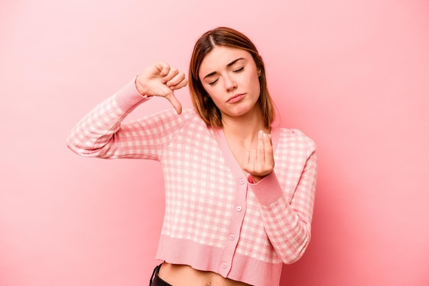 Young caucasian woman isolated on pink background showing that she has no money