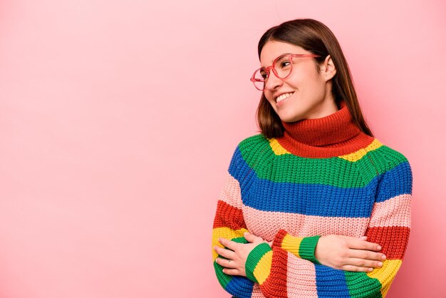 Young caucasian woman isolated on pink background smiling confident with crossed arms