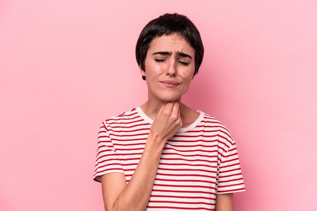 Young caucasian woman isolated on pink background suffers pain in throat due a virus or infection.