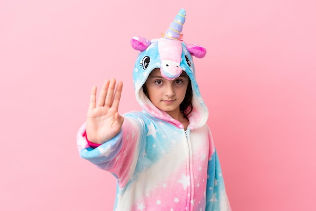 Young caucasian woman isolated on pink background surprised and pointing finger to the side