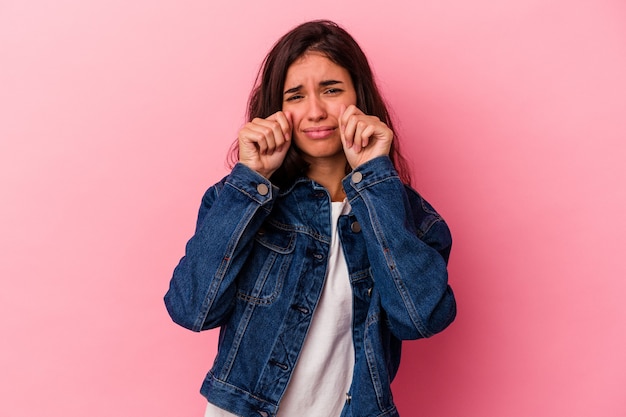 Young caucasian woman isolated on pink background whining and crying disconsolately.