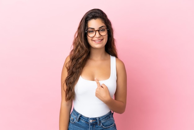 Young caucasian woman isolated on pink background with surprise facial expression