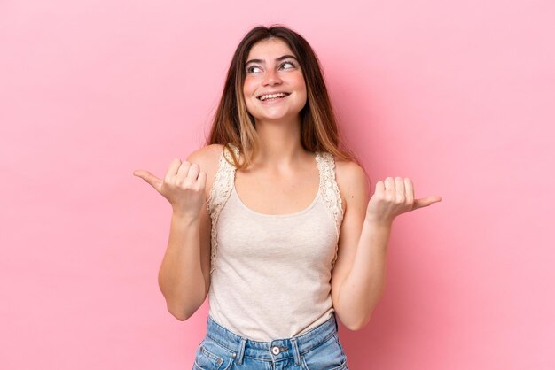 Young caucasian woman isolated on pink background with thumbs up gesture and smiling