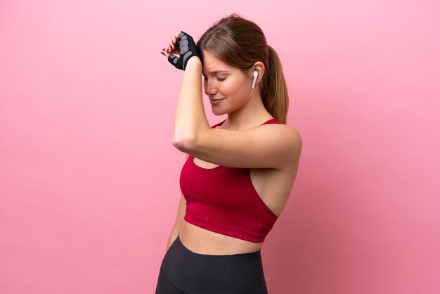 Young caucasian woman isolated on pink background with tired expression