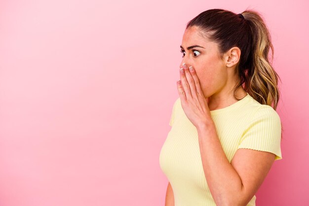 Young caucasian woman isolated on pink background