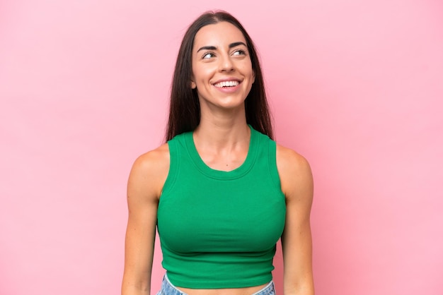 Young caucasian woman isolated on pink background