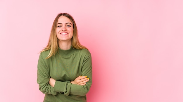 Young caucasian woman isolated on pink laughing and having fun.