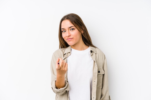 Foto la giovane donna caucasica ha isolato indicare con il dito come se l'invito si avvicini.