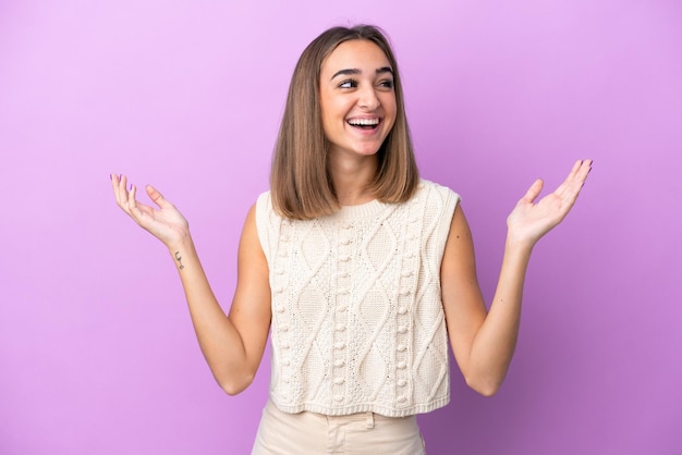 Young caucasian woman isolated on purple background smiling a lot