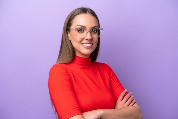 Young caucasian woman isolated on purple background With glasses with happy expression