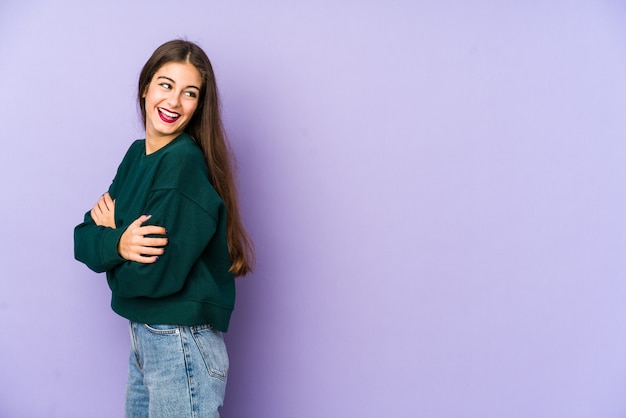 Young caucasian woman isolated on purple laughing and having fun