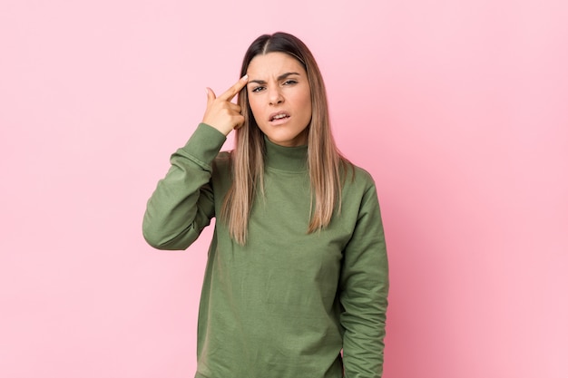 Young caucasian woman isolated showing a disappointment gesture with forefinger.