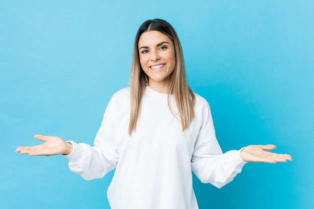 Young caucasian woman isolated showing a welcome expression.