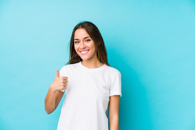 Young caucasian woman  isolated smiling and raising thumb up
