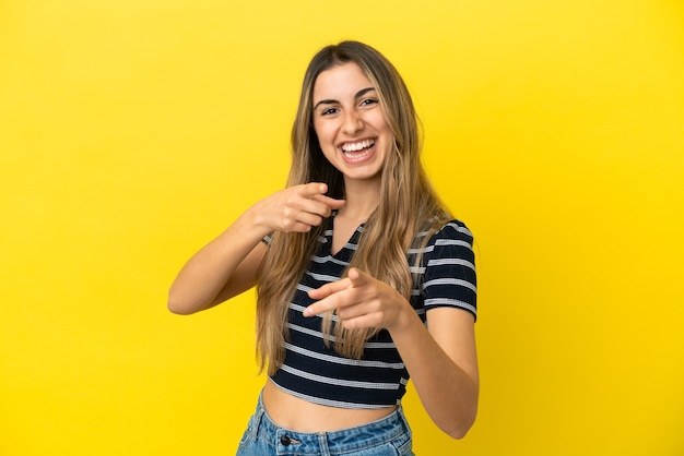 Young caucasian woman isolated surprised and pointing front