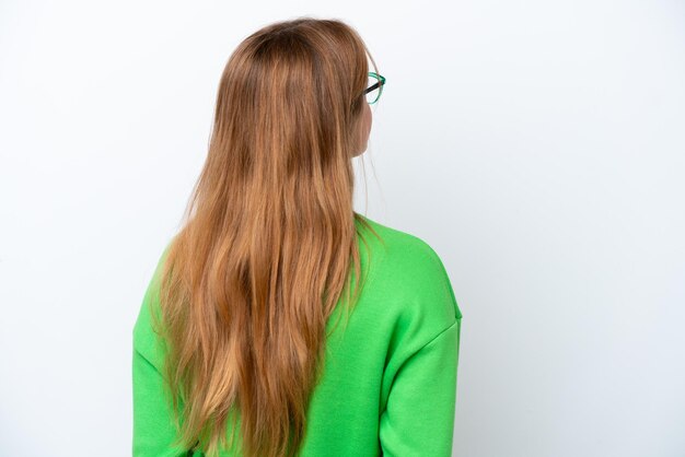 Young caucasian woman isolated on white background in back position and looking back