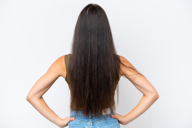 Young caucasian woman isolated on white background in back position