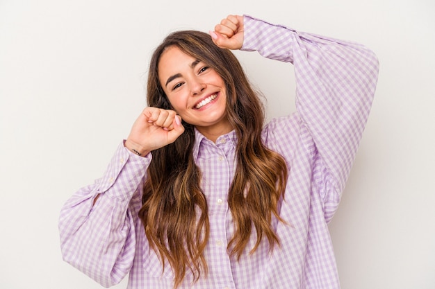 Young caucasian woman isolated on white background celebrating a special day, jumps and raise arms with energy.