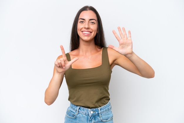 Young caucasian woman isolated on white background counting seven with fingers