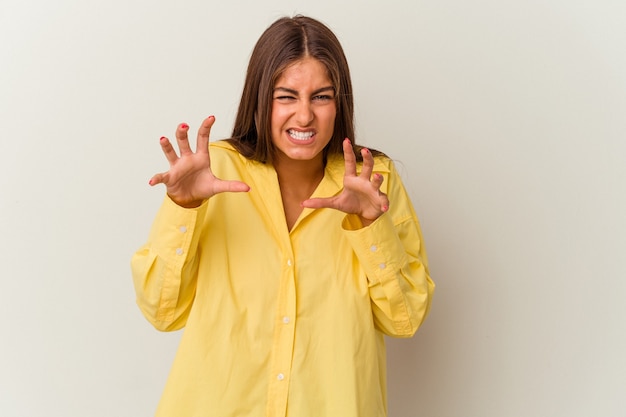 Young caucasian woman isolated on white background covering mouth with hands looking worried.