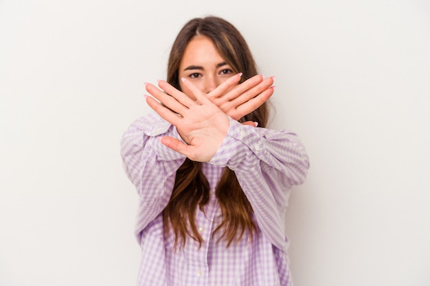 Young caucasian woman isolated on white background doing a denial gesture