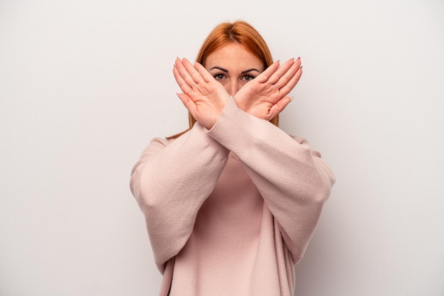 Young caucasian woman isolated on white background doing a denial gesture