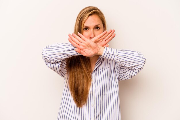 Young caucasian woman isolated on white background doing a denial gesture