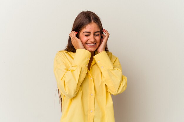 Young caucasian woman isolated on white background doubting between two options.