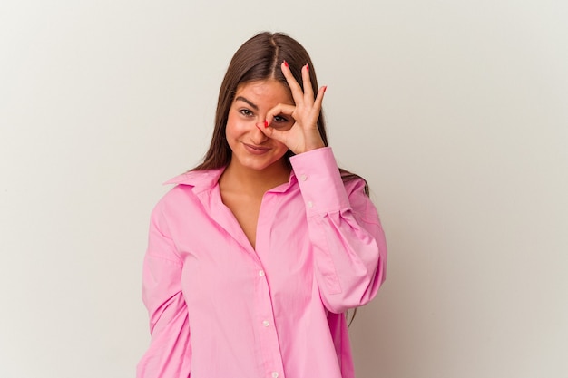 Young caucasian woman isolated on white background excited keeping ok gesture on eye.