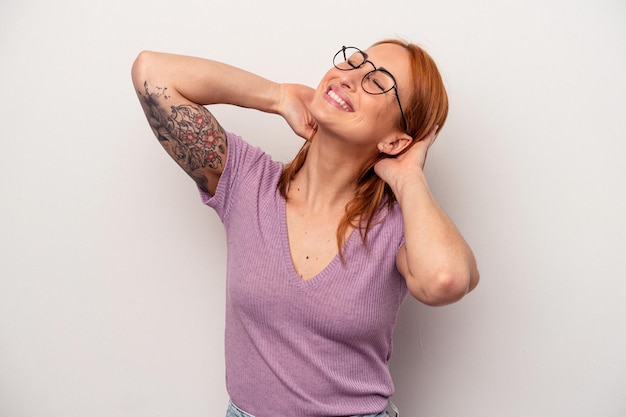 Young caucasian woman isolated on white background feeling confident, with hands behind the head.