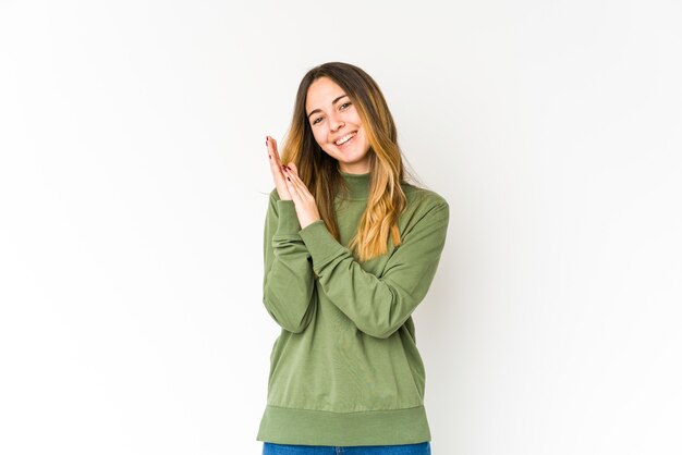 Young caucasian woman isolated on white background feeling energetic and comfortable, rubbing hands confident.