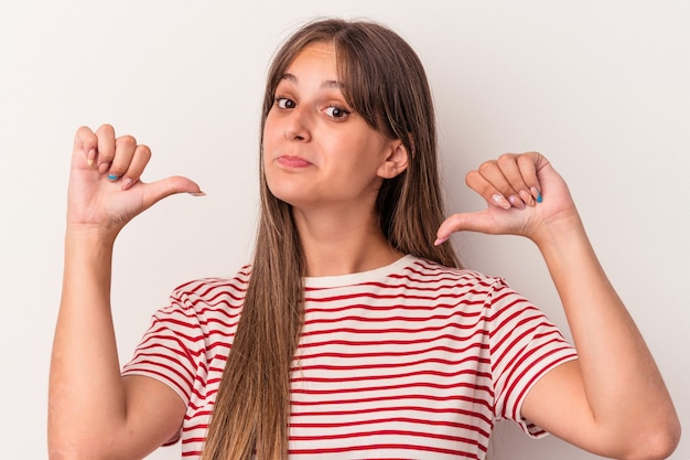 Young caucasian woman isolated on white background feels proud and self confident, example to follow.