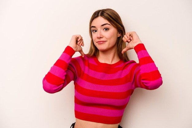 Young caucasian woman isolated on white background feels proud and self confident example to follow