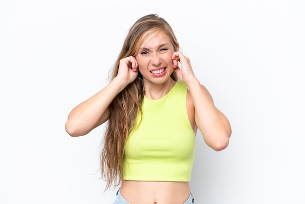 Young caucasian woman isolated on white background frustrated and covering ears