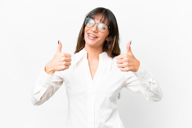 Young caucasian woman over isolated white background giving a thumbs up gesture