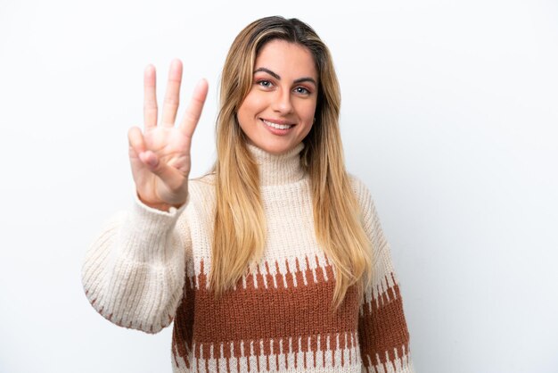 Young caucasian woman isolated on white background happy and counting three with fingers