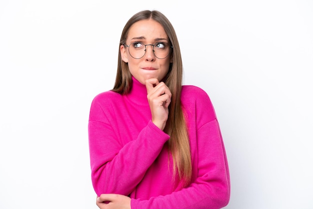 Young caucasian woman isolated on white background having doubts and thinking