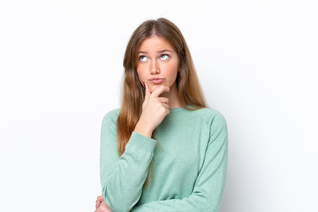 Young caucasian woman isolated on white background having doubts