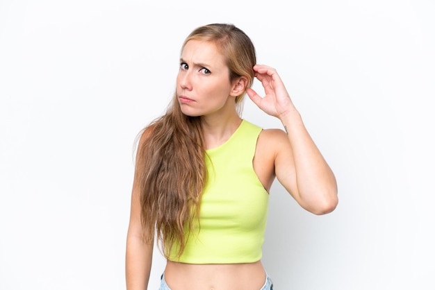 Young caucasian woman isolated on white background having doubts