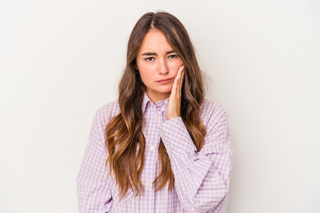 Young caucasian woman isolated on white background having a strong teeth pain, molar ache.